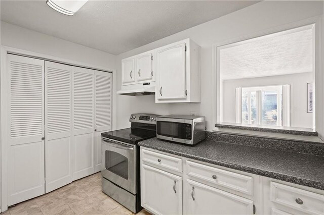 kitchen featuring white cabinets and appliances with stainless steel finishes