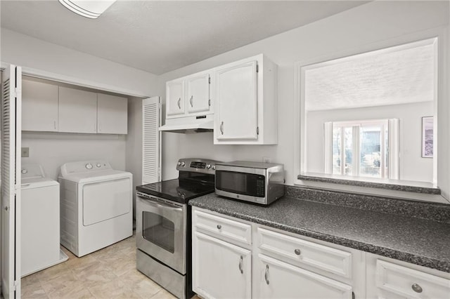 kitchen with stainless steel appliances, separate washer and dryer, and white cabinets