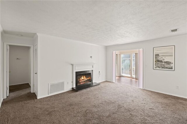 unfurnished living room featuring dark carpet and a textured ceiling