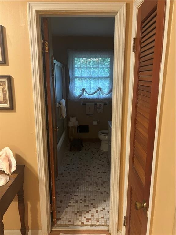 hallway with tile patterned flooring