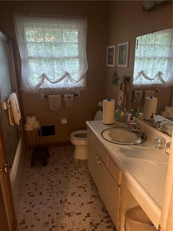 bathroom with tile patterned floors, vanity, and toilet