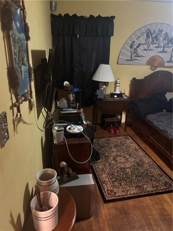 bedroom with wood-type flooring