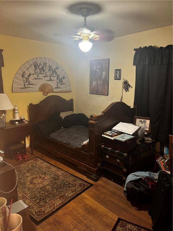 bedroom featuring hardwood / wood-style flooring and ceiling fan