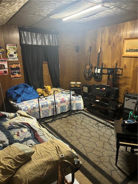 bedroom with wood walls