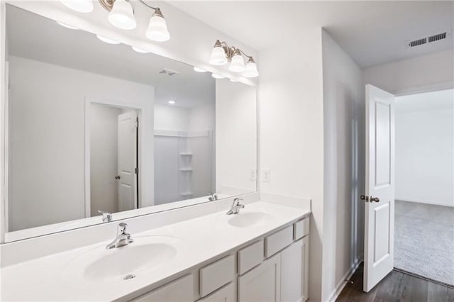 bathroom with vanity and hardwood / wood-style flooring