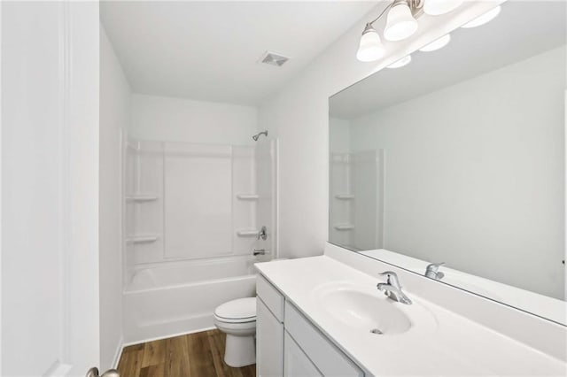 full bathroom featuring tub / shower combination, vanity, toilet, and hardwood / wood-style flooring