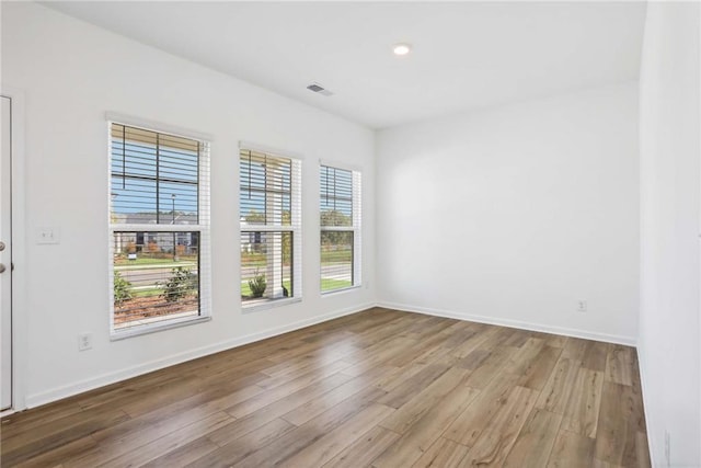 spare room with hardwood / wood-style floors