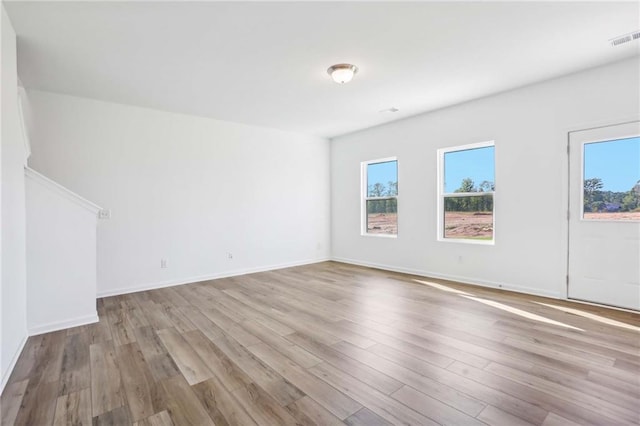 unfurnished room with light wood-type flooring