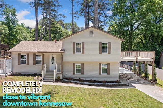 3050 Woodland Dr NW, Kennesaw, GA 30152 - tri-level home featuring driveway, a front lawn, and an attached carport