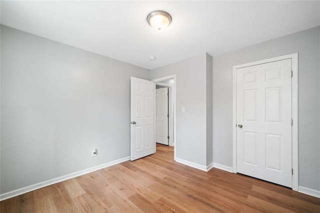 3050 Woodland Dr NW, Kennesaw, GA 30152 - unfurnished bedroom featuring light wood-style floors and baseboards
