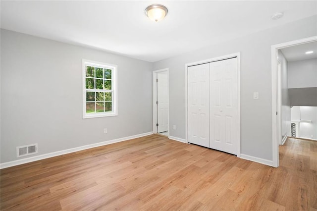 3050 Woodland Dr NW, Kennesaw, GA 30152 - unfurnished bedroom with light wood-style floors, baseboards, and a closet