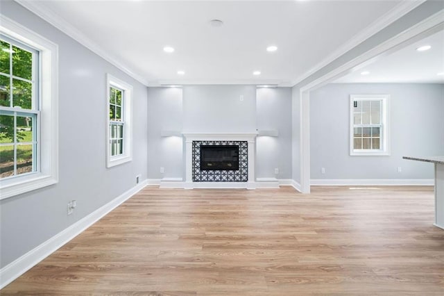 3050 Woodland Dr NW, Kennesaw, GA 30152 - unfurnished living room with ornamental molding, light wood-style flooring, recessed lighting, baseboards, and a tile fireplace