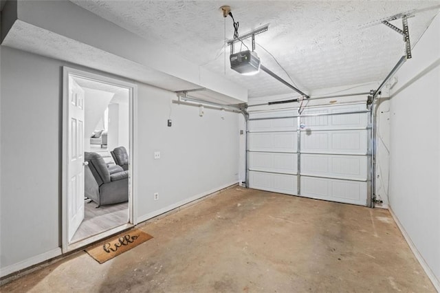 garage with a garage door opener and baseboards