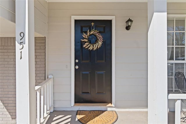 doorway to property with brick siding