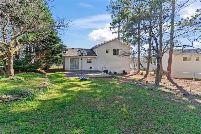 rear view of house featuring a patio and a lawn