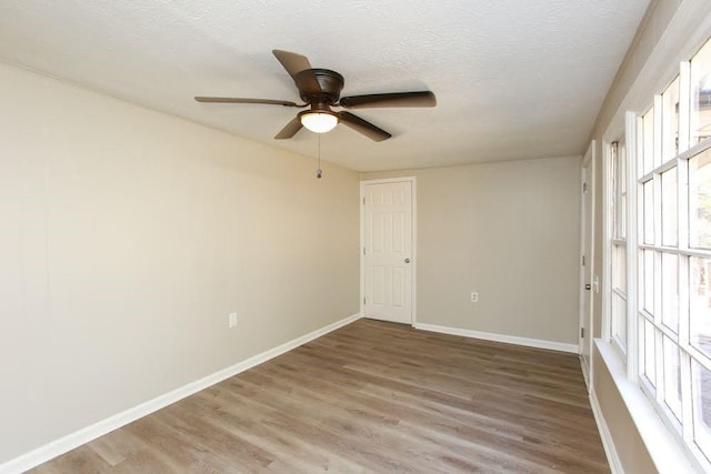 272 Old Sudie Rd, Hiram, GA 30141 - unfurnished room featuring a ceiling fan, light wood-style floors, baseboards, and a textured ceiling