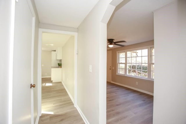 272 Old Sudie Rd, Hiram, GA 30141 - hallway featuring light wood-style floors, arched walkways, and baseboards