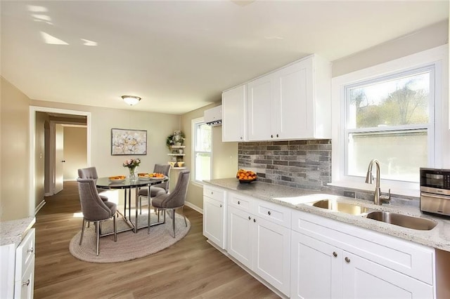 272 Old Sudie Rd, Hiram, GA 30141 - kitchen with a sink, white cabinets, tasteful backsplash, and light wood-style flooring