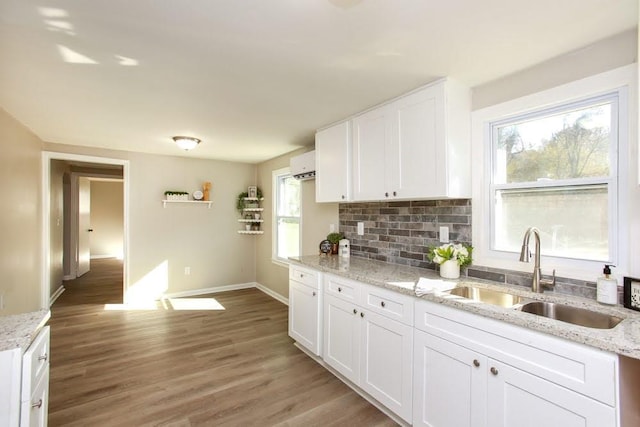 272 Old Sudie Rd, Hiram, GA 30141 - kitchen featuring a sink, baseboards, light wood-type flooring, white cabinets, and tasteful backsplash