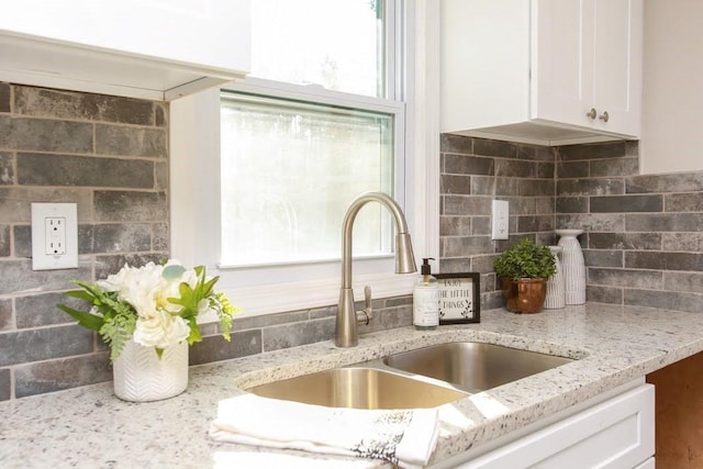 272 Old Sudie Rd, Hiram, GA 30141 - kitchen view of a sink, white cabinets, light stone countertops, and tasteful backsplash