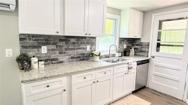 272 Old Sudie Rd, Hiram, GA 30141 - kitchen with dishwasher, a sink, white cabinets, light wood-style floors, and decorative backsplash