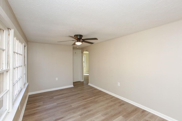 272 Old Sudie Rd, Hiram, GA 30141 - unfurnished room featuring light wood-style floors, ceiling fan, baseboards, and a textured ceiling