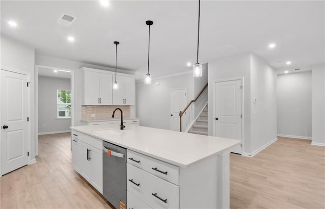 kitchen with visible vents, light wood-type flooring, dishwasher, a sink, and light countertops