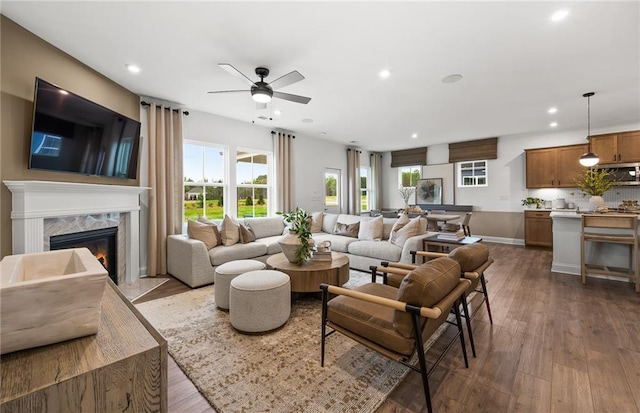 living room featuring recessed lighting, ceiling fan, wood finished floors, and a premium fireplace