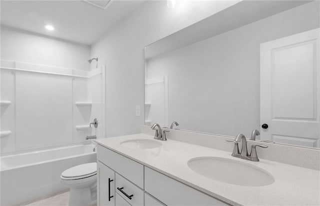 bathroom with double vanity, a sink, washtub / shower combination, and toilet