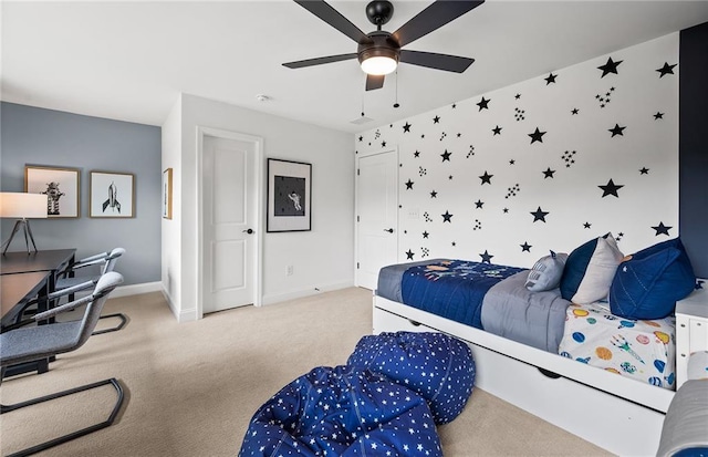 carpeted bedroom featuring baseboards and ceiling fan