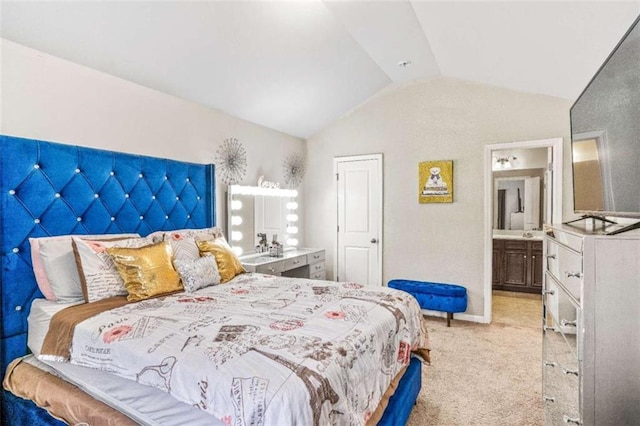 carpeted bedroom with vaulted ceiling, baseboards, and ensuite bathroom