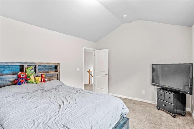 carpeted bedroom featuring baseboards and lofted ceiling