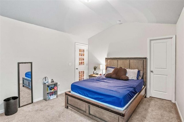 carpeted bedroom featuring baseboards and vaulted ceiling