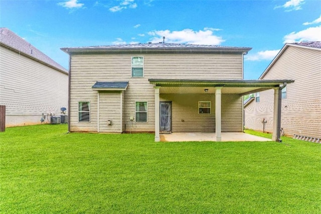 rear view of property featuring a patio area and a lawn