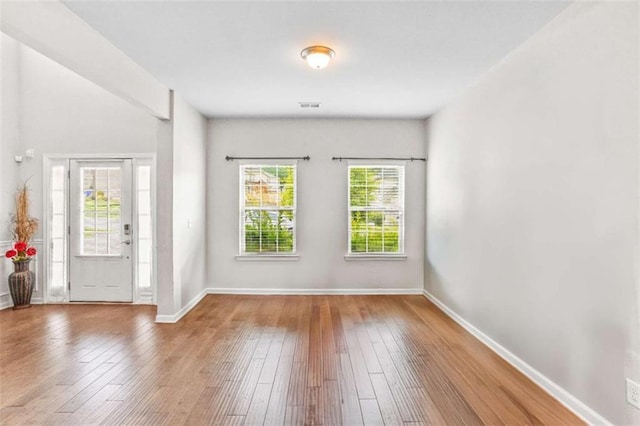 entryway with visible vents, baseboards, and hardwood / wood-style flooring