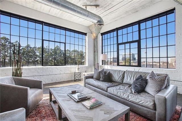 living room featuring brick wall