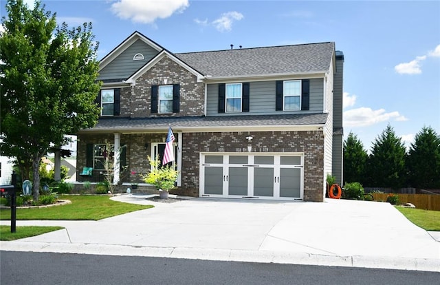 view of front of home featuring a front yard and a garage