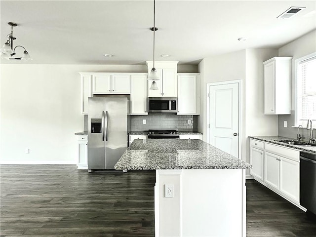 3658 Hidden Valley Cir, Lawrenceville, GA 30044 - kitchen featuring dark wood-style floors, a sink, stone counters, appliances with stainless steel finishes, and white cabinetry