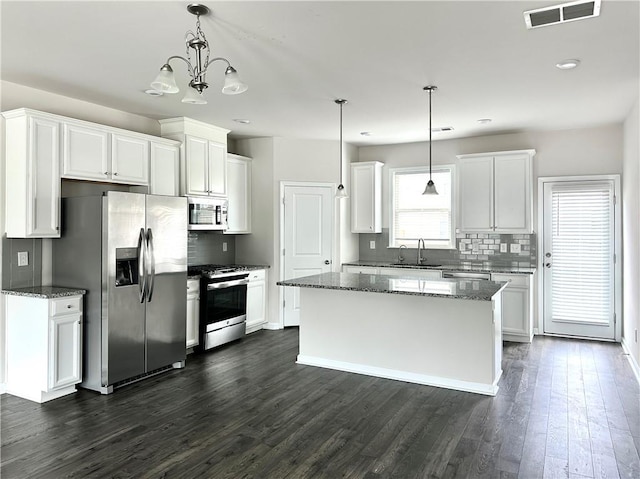 3658 Hidden Valley Cir, Lawrenceville, GA 30044 - kitchen with visible vents, backsplash, appliances with stainless steel finishes, and dark wood finished floors
