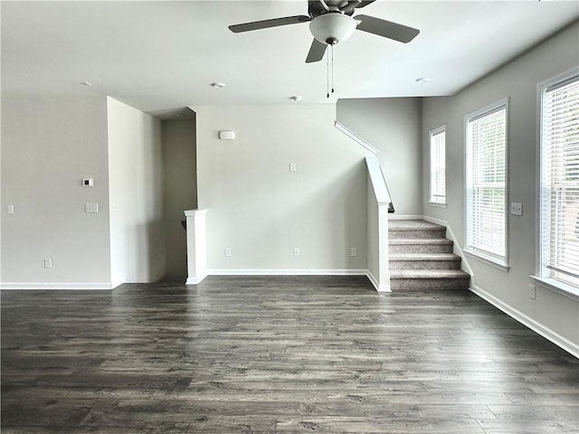 3658 Hidden Valley Cir, Lawrenceville, GA 30044 - unfurnished living room featuring plenty of natural light, dark wood-style floors, stairway, and ceiling fan