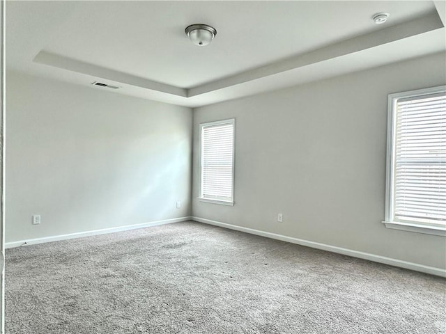 3658 Hidden Valley Cir, Lawrenceville, GA 30044 - unfurnished room with a tray ceiling, carpet, visible vents, and baseboards