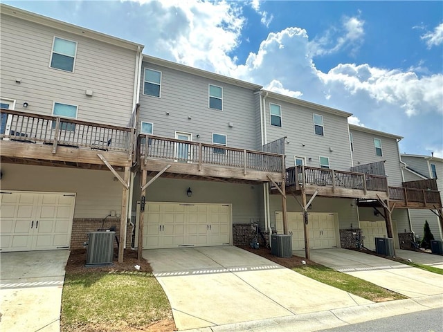 3658 Hidden Valley Cir, Lawrenceville, GA 30044 - back of house with central AC, brick siding, driveway, and a garage
