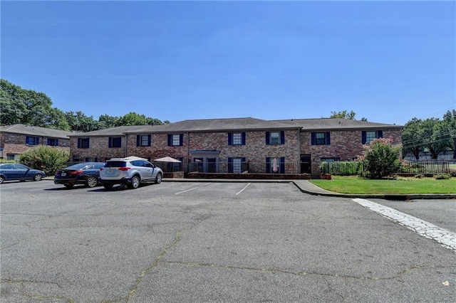 view of building exterior with uncovered parking