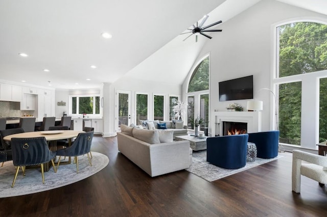 330 Longvue Ct, Johns Creek, GA 30097 - living area with high vaulted ceiling, healthy amount of natural light, a ceiling fan, a lit fireplace, and recessed lighting