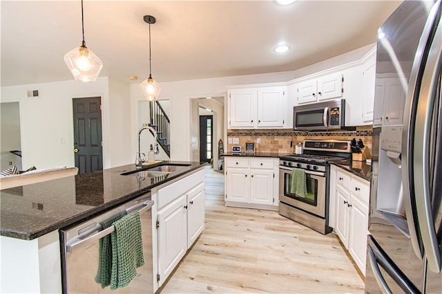 4222 Honey Creek Way, Powder Springs, GA 30127 - kitchen with white cabinetry, a sink, stainless steel appliances, light wood finished floors, and backsplash
