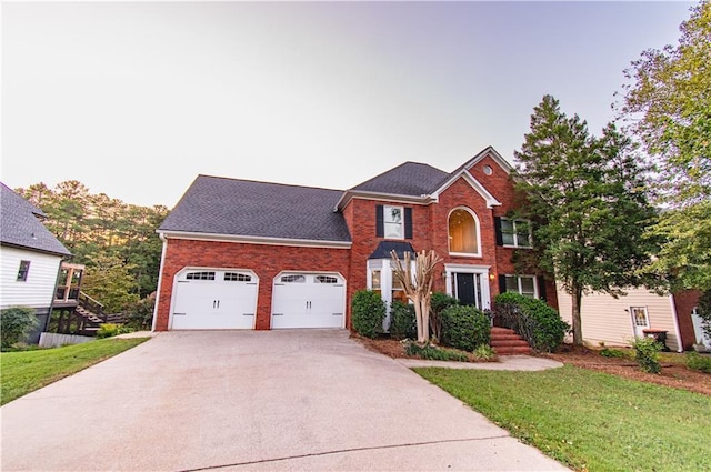 front of property featuring a garage and a front lawn