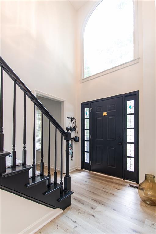 4222 Honey Creek Way, Powder Springs, GA 30127 - foyer entrance with wood finished floors, stairs, and a towering ceiling