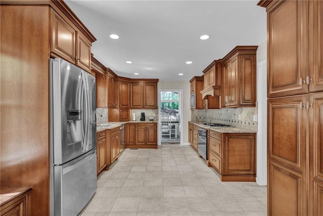 1819 Yorkshire Dr, Woodstock, GA 30189 - kitchen featuring recessed lighting, light stone countertops, brown cabinets, decorative backsplash, and appliances with stainless steel finishes