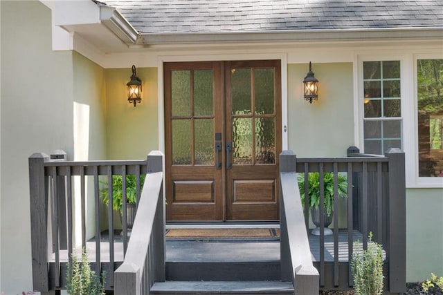 1819 Yorkshire Dr, Woodstock, GA 30189 - view of exterior entry featuring french doors, stucco siding, and a shingled roof
