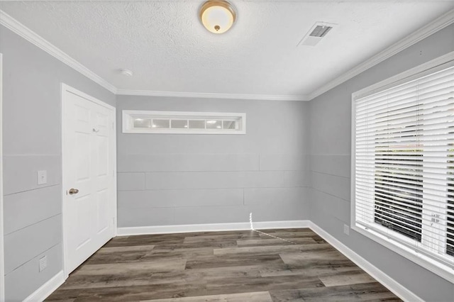 unfurnished room with dark wood-type flooring, a textured ceiling, and ornamental molding